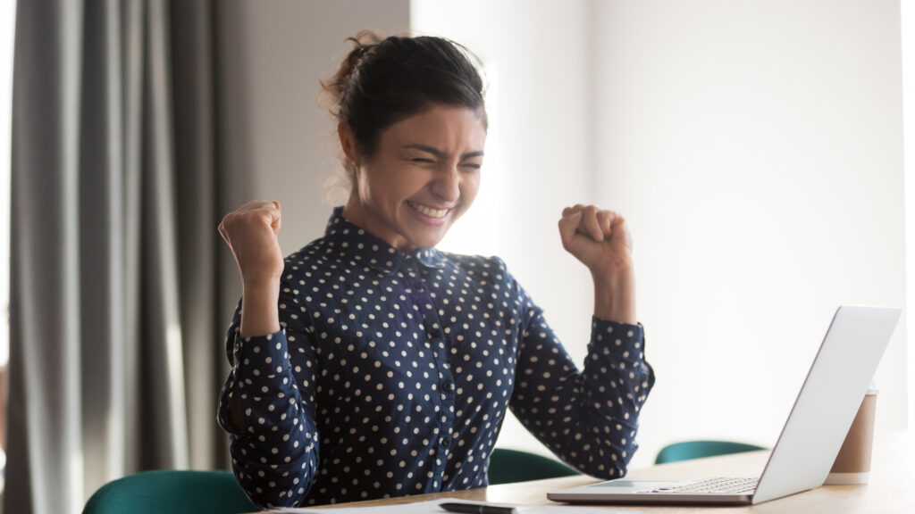 Excited happy indian employee celebrating success