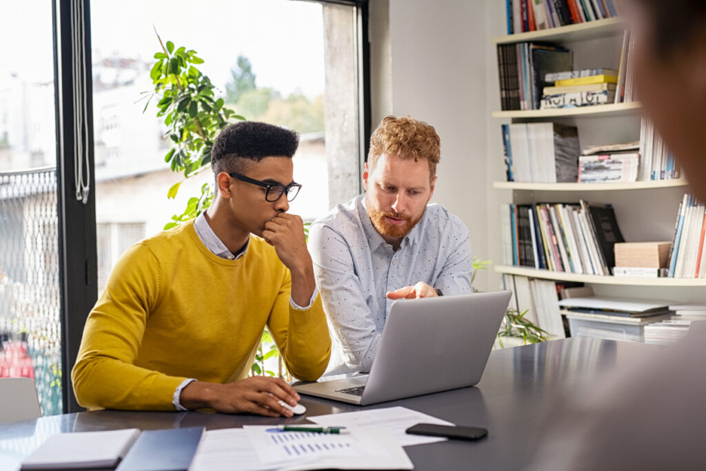 Office workers choosing email campaign templates.