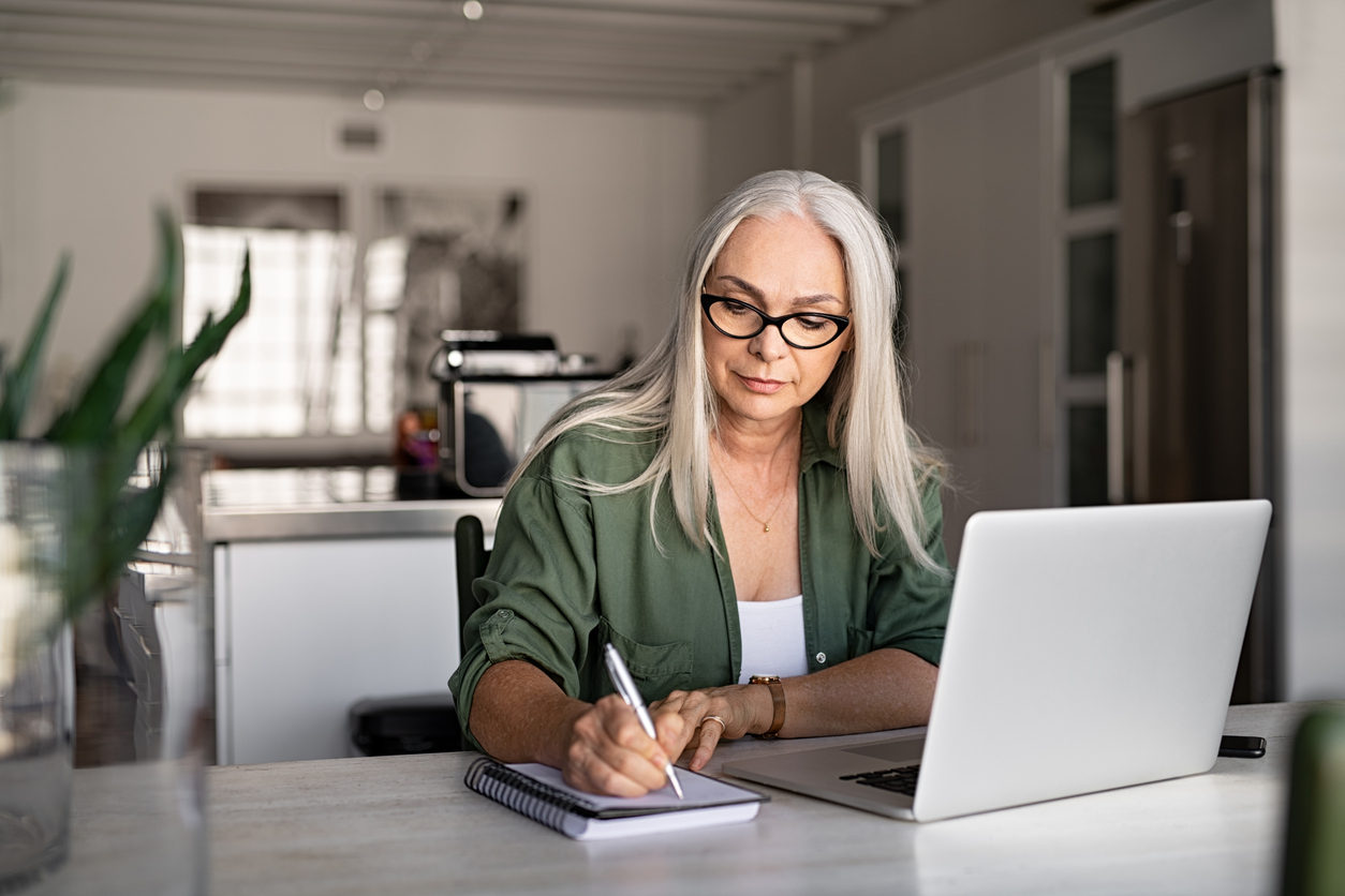 Woman taking notes on ActiveCampaign email sequences