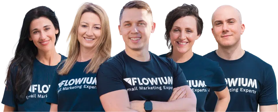 Flowium email marketing team members standing together, smiling and wearing navy Flowium branded t-shirts.